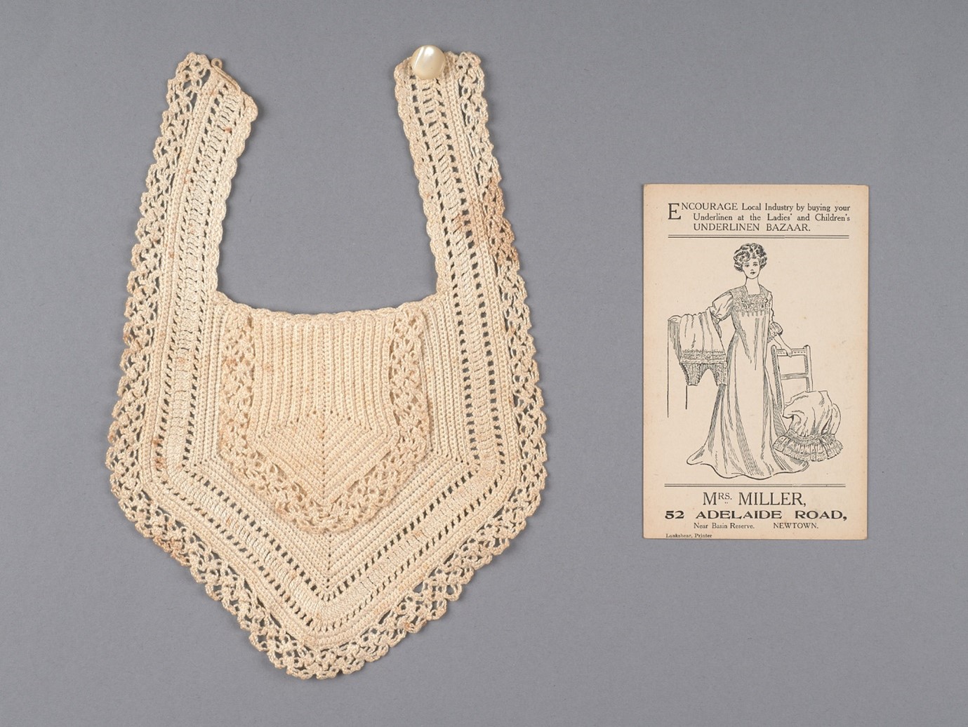 A bib made by Laura for her grand-daughter Audrey Inkersell, alongside an example of her advertising material