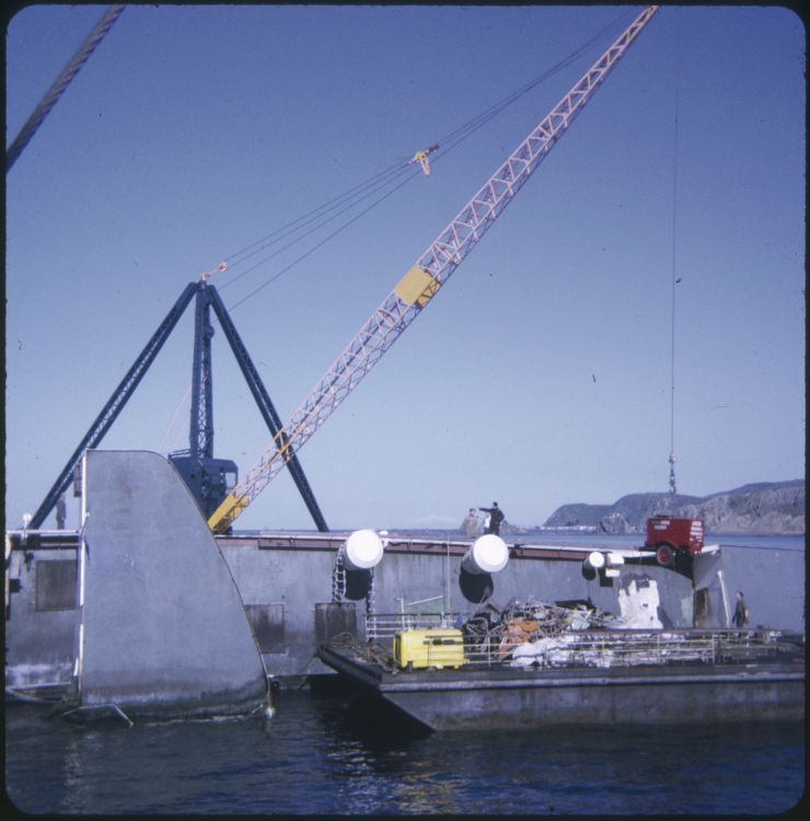 A barge in front of the Wahine wreck and a crane behind the TEV Wahine wreck lifting a generator