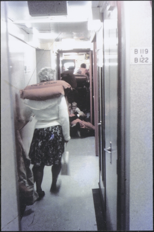Woman passenger in lifejacket in passageway