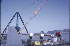 A barge in front of the Wahine wreck and a crane behind the TEV Wahine wreck lifting a generator