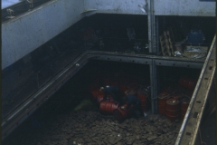 Men working in the  cargo hold of salvage vessel Holmpark at the TEV Wahine wreck.